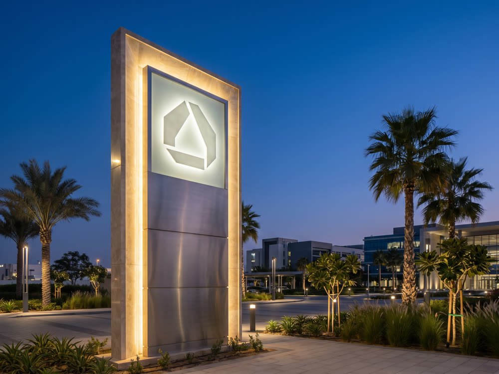 Freestanding illuminated pylon sign at dusk